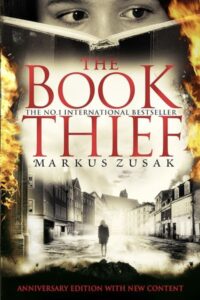 In the haunting cover of Markus Zusak’s The Book Thief, the burning edges, the solitary figure walking through a war-torn street, and the child’s eyes peering over an open book all tell a silent story of survival, words, and resistance during the horrors of Nazi Germany. What secrets lie within the pages that could challenge death itself? Explore how this cover perfectly captures the novel’s soul — a tale where books become both a weapon and a refuge."
